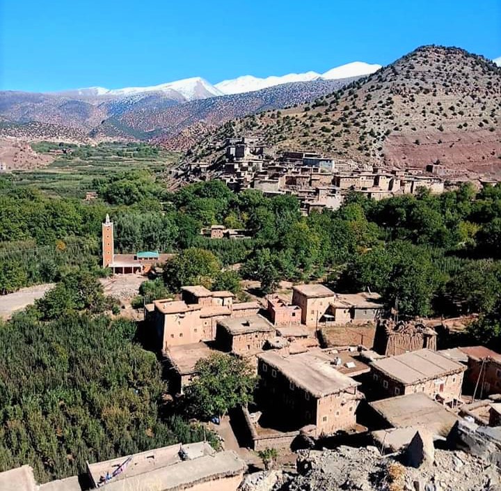A sight of greenery, snow, mountains and desert lands from the top near atlas mountains