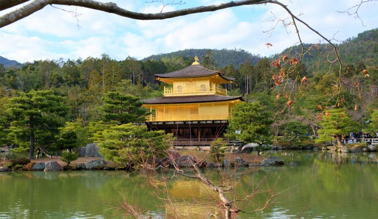 Golden temple reflects of the green water in front of it