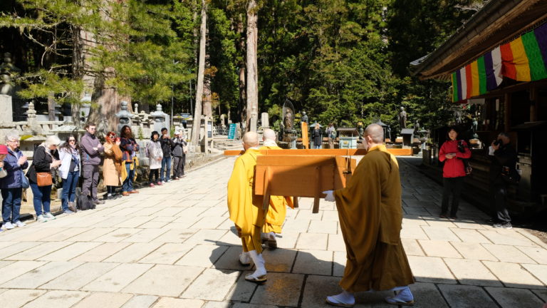 3 Monks carry food to Kobo Dashi during the morning ceremony in okunoin cemetery Mount Koya Japan