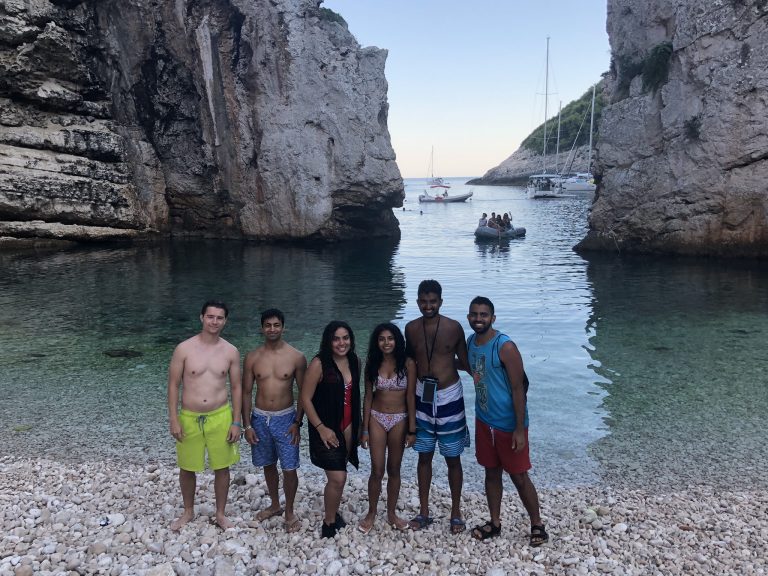 Group poses for picture in front of Stiniva beach