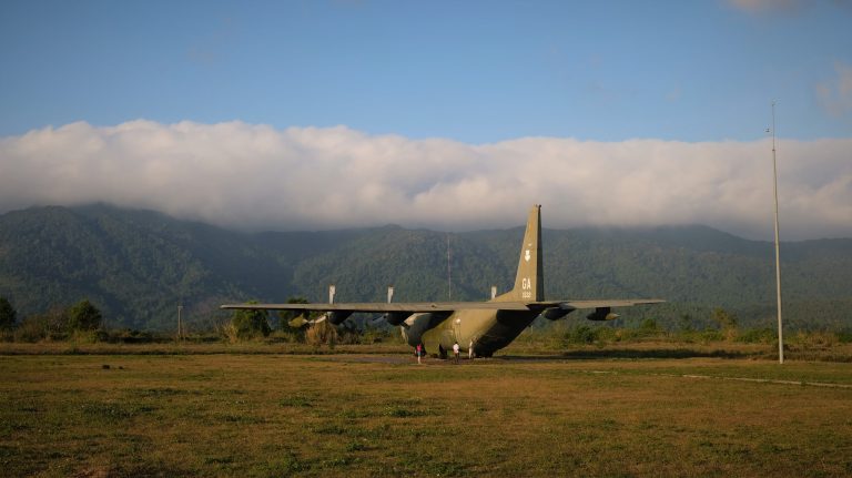 American airplane sits infront of mountain backdrop in Khe San