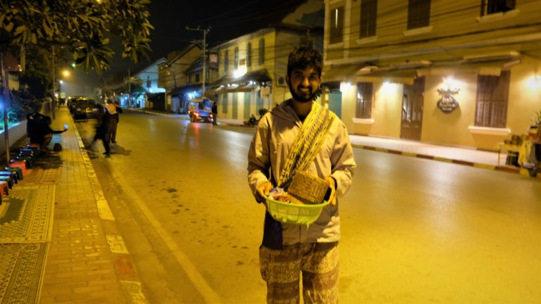 Nishil Holding food in Laos Suit