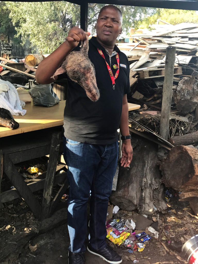 Tour Guide Holding Goat Head