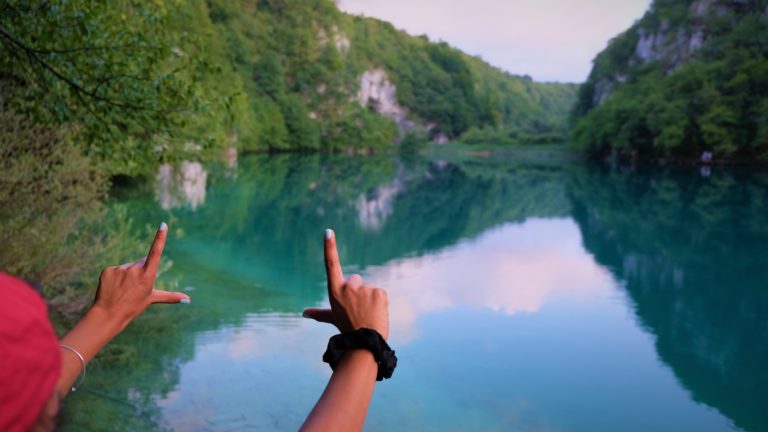 Hands outlining Plitvice Lake beauty