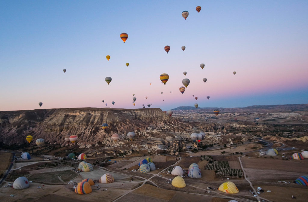 Balloons rise over Cappadocia's valley early in the morning