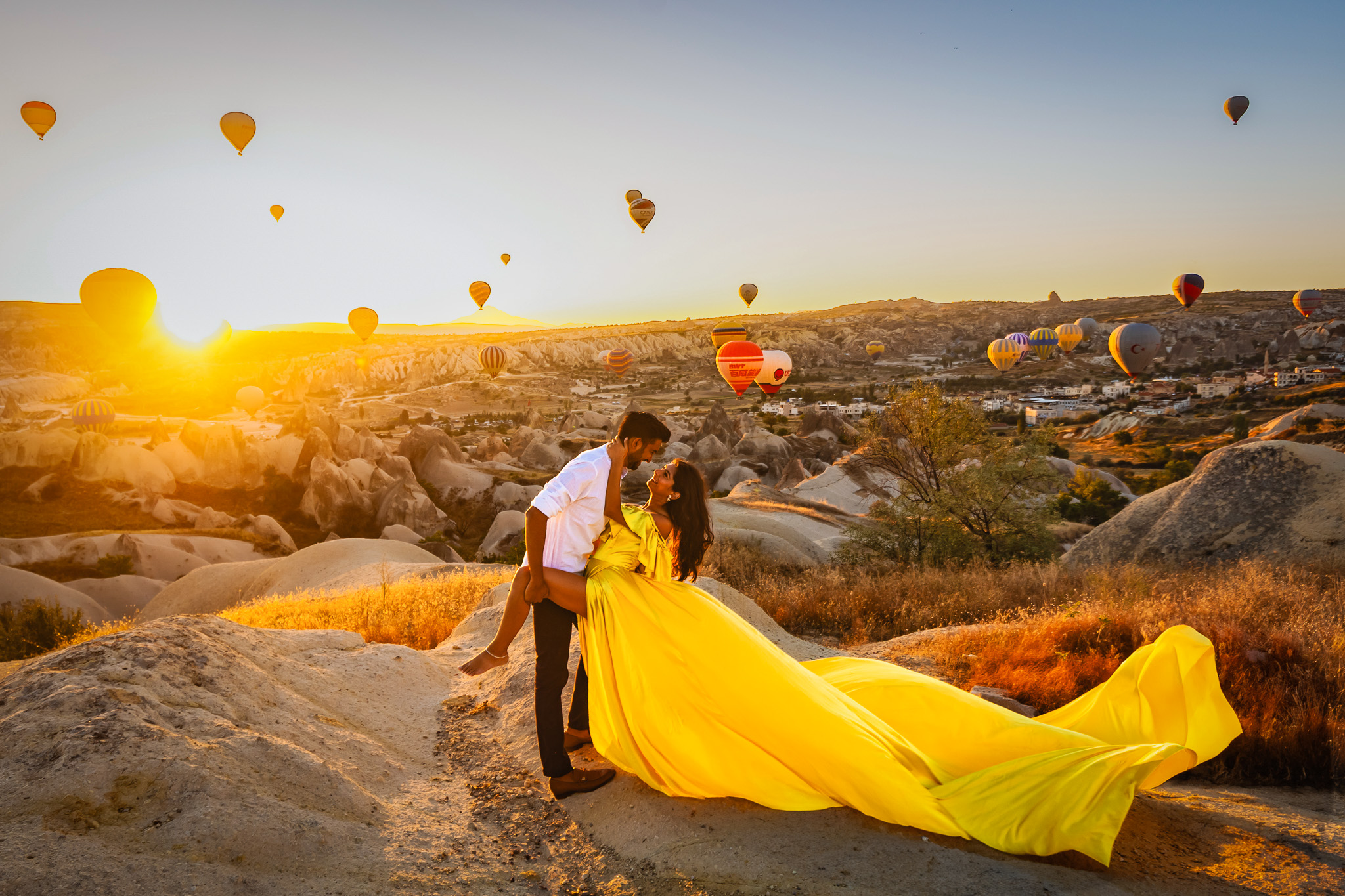 Nishil and Anmol pose in front of rising balloons