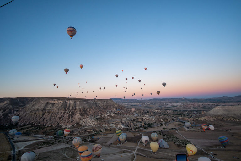 Balloons rise over Cappadocia's valley early in the morning