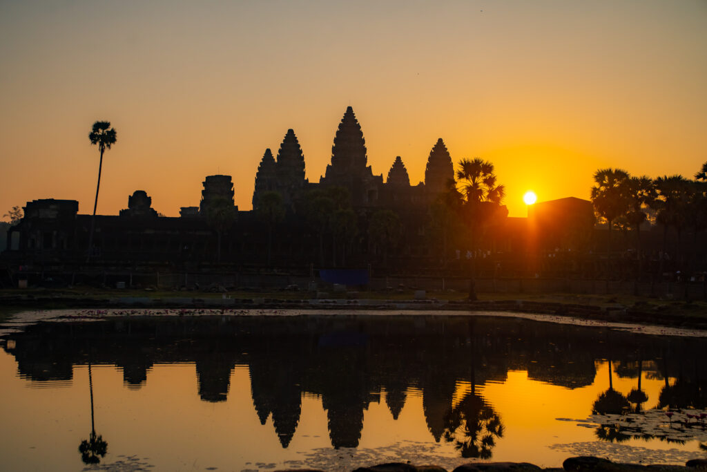 Sun rises behind Angkor Wat