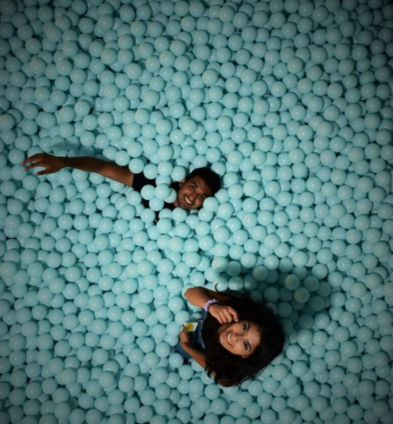 Nishil and Anmol take a picture from above in a blue ball pit