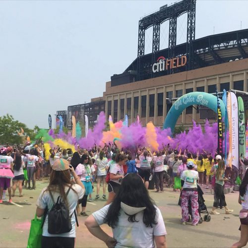 Powdered color flys into the air in front of Citi field