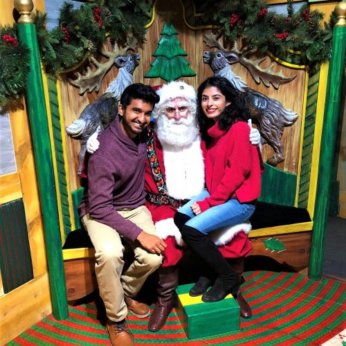 Nishil and Anmol pose with Santa at Macy's